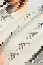 Detail shot of collar and front rhinestone bow embellishments