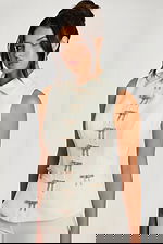 Three-quarter front view of ivory pant suit with crystal bow accents and collar