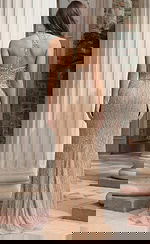 Back view of fitted beaded gown with illusion panel and central strap detail