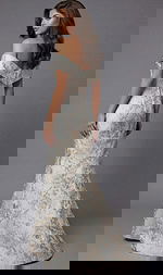 Back view of an off the shoulder evening gown with a fitted silhouette and floor length skirt