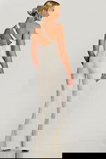 Side-back angle of fitted ivory jumpsuit with asymmetrical neckline and floral detail