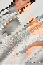 Detail of pearl-centered floral appliqués on textured satin fabric