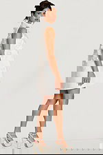 Side profile of floral appliqué dress showing A-line silhouette