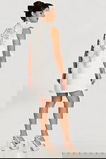 Three-quarter back view of 3D floral sleeveless dress with soft flare