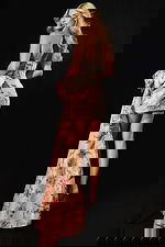 Back view of floral jacquard mini dress with bow detail and flowing train