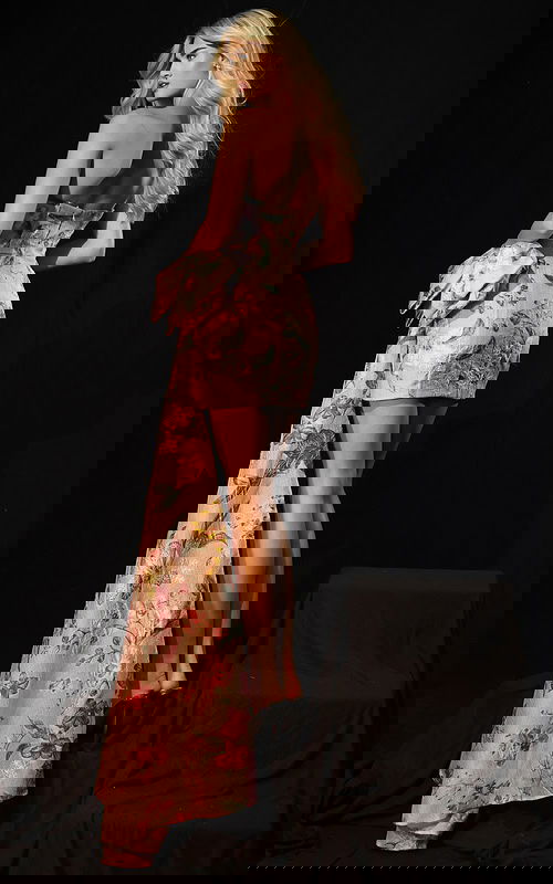 Elegant short floral dress with textured fabric and dramatic bow accent