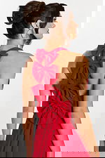 Close-up of triple bow detail on red halter mini dress