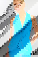 Close-up of blue sleeveless jumpsuit showing lapel and button details