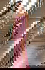 Fitted gown with twisted bodice, subtle cutout detail, and a thigh high slit creating a sleek, feminine silhouette