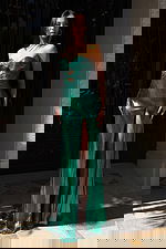 Shiny emerald gown featuring strapless neckline and side slit