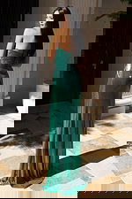 Green fitted formal dress with front cutouts and floor-length skirt