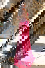 Shiny fuchsia gown with thigh-high slit and form-fitting silhouette