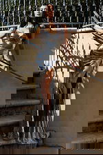 Fitted metallic gown with deep neckline and thigh-high slit