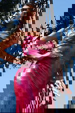 Bright fuchsia gown featuring spaghetti straps and sleek fit