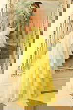 Flowing tiered gown with structured bodice design