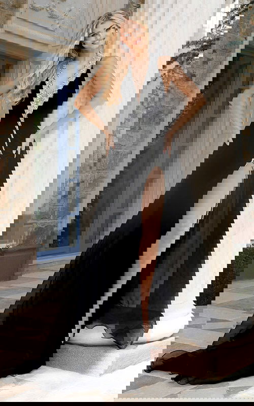 Glamorous black formal dress featuring a deep V-neckline and slit