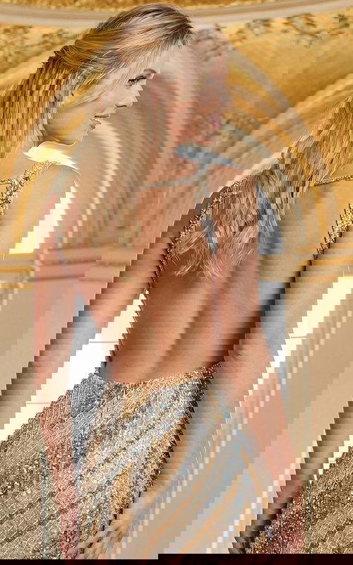 Back view of a sleeveless short formal dress with an open back and beaded pattern