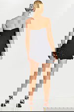 Back view of short black dress with floral trim and zip closure