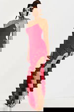 Side angle of red evening gown with sculpted bodice and 3D rosettes cascading from slit