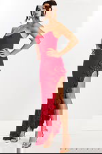 Three-quarter angle showing red floral gown with structured neckline and high slit