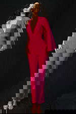 Elegant deep V-neck jumpsuit with flowing cape accent