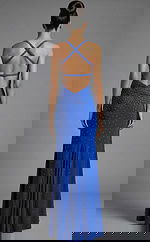 Back view of fitted evening gown with crisscross straps, open back, and scattered crystal embellishments