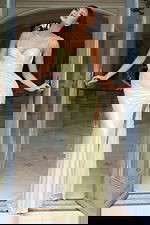 Front view of fitted rhinestone gown with high slit and spaghetti straps