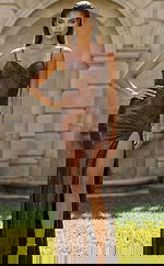 Fitted embellished gown with thin straps, ruched bodice, and thigh high slit in a sleek silhouette