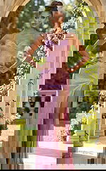 Front view of fitted embellished gown with ruched bodice, thin straps, and thigh high slit