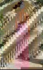 Back view of fitted embellished gown with low open back, thin straps, and softly flared hem