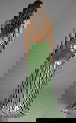 Back view of a fitted gown with an open back, thin straps, and a floor length skirt with subtle sparkle