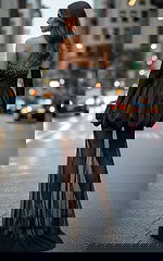 Elegant woman in a strapless black dress with pearl beading and sheer mesh train walking