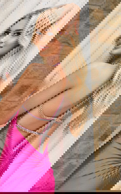 Hot pink halter prom dress with crystal beaded neckline and fitted silhouette