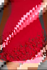 Close-up of black satin rose appliqués on hem of dress