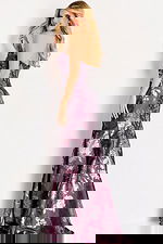 Strapless floral jacquard gown with a fitted mermaid silhouette and soft metallic sheen throughout the pattern.