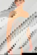 One-shoulder ivory midi dress with sculpted neckline, high slit, and fitted waist