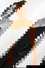 Close-up of structured bodice and floral side accent on black jumpsuit