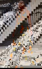 Halter neck gown with front cutout detail and flowing skirt featuring bold floral print