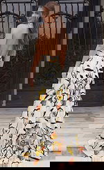 Open-back halter gown with flowing skirt and bold floral print in lightweight fabric