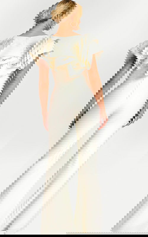 Back view of fitted white jumpsuit with voluminous shoulder ruffles