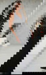 Front view of fitted halter gown with plunging neckline, ruched waist, and subtle crystal embellishments