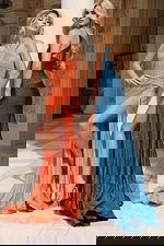 Two models wearing shimmer gowns in orange and teal with thigh-high slits