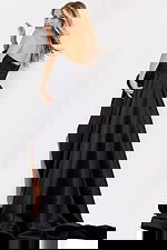 Flowing black evening dress with dramatic train and side slit