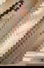 Strapless beaded bridal gown with flowing skirt and detailed texture