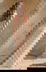 Back view of bridal gown with sheer fabric and intricate beadwork