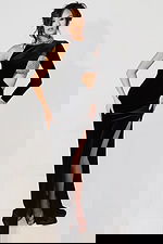 Black velvet one-shoulder gown with crystal embellished collar and cuff, dramatic cutout waist, and high thigh slit