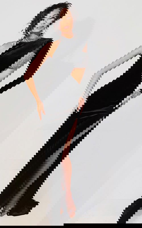 Black velvet one-shoulder gown with crystal embellished collar and cuff, dramatic cutout waist, and high thigh slit