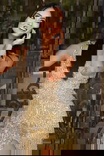 Gold sequin gown with open back and tiered fringe embellishments