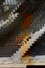 Gold halter sequin prom dress with fringe details and thigh-high slit