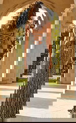 Back view of fitted embellished gown with lace up back, thin straps, and vertical beaded detailing